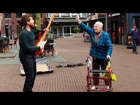 Joyful Grandma dancing with Street Performer