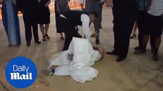 Groom knocks his new bride over during cake smash fail!