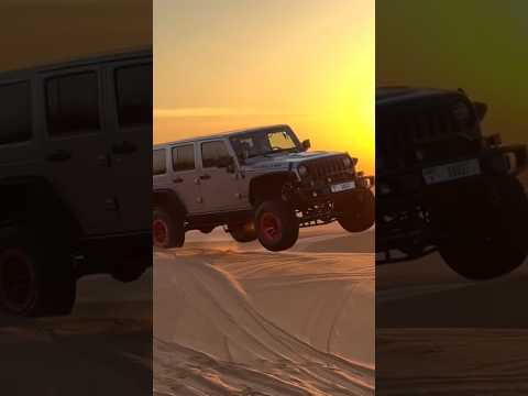 Witness the breathtaking beauty of a jeep driving through the stunning desert