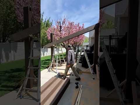 Installing Pre-Stained Beams on Backyard Pergola Posts | Remodelaholic