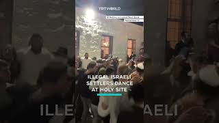 Israeli settlers dance at holy site in occupied West Bank