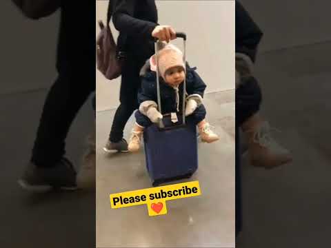 cute baby on suitcase on airport|