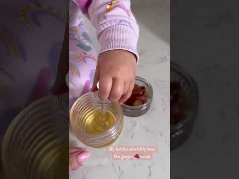 Easy frozen gapes snack for toddlers.  Toddler in action 😅 she loves to prepare her food