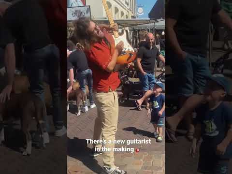 New guitarist in the making! Street performer inspires kid