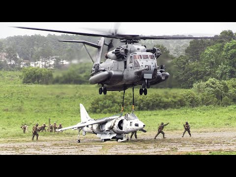 U.S. Marines lifting AV-8B Harrier II jet with CH-53E Super Stallion