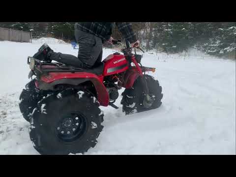 Lifted ATC 200E big red playing in the backyard snow