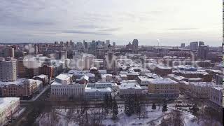 Aerial view of winter cityscape with buildings, parks, and roads. Clip. Drone view of the town with