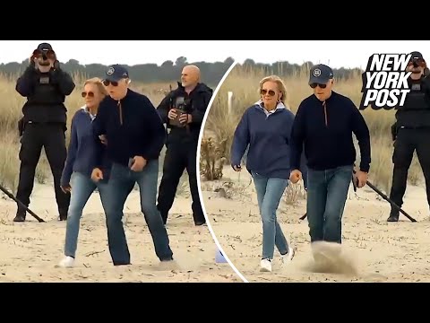 Biden stumbles multiple times, needs assist from Jill as he struggles to walk on Delaware beach