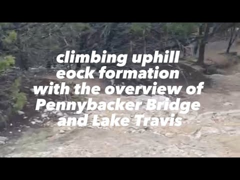 climbing uphill eock formation with the overview of Pennybacker Bridge and Lake Travis