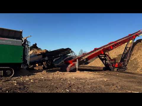 Komptech Crambo 6000 Dual-Shaft Shredder Teamed up with Screencore 4100 Tracked Stacker - in Mulch!