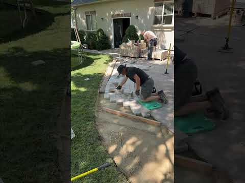 Laying pavers on 1” sand base around an existing patio.